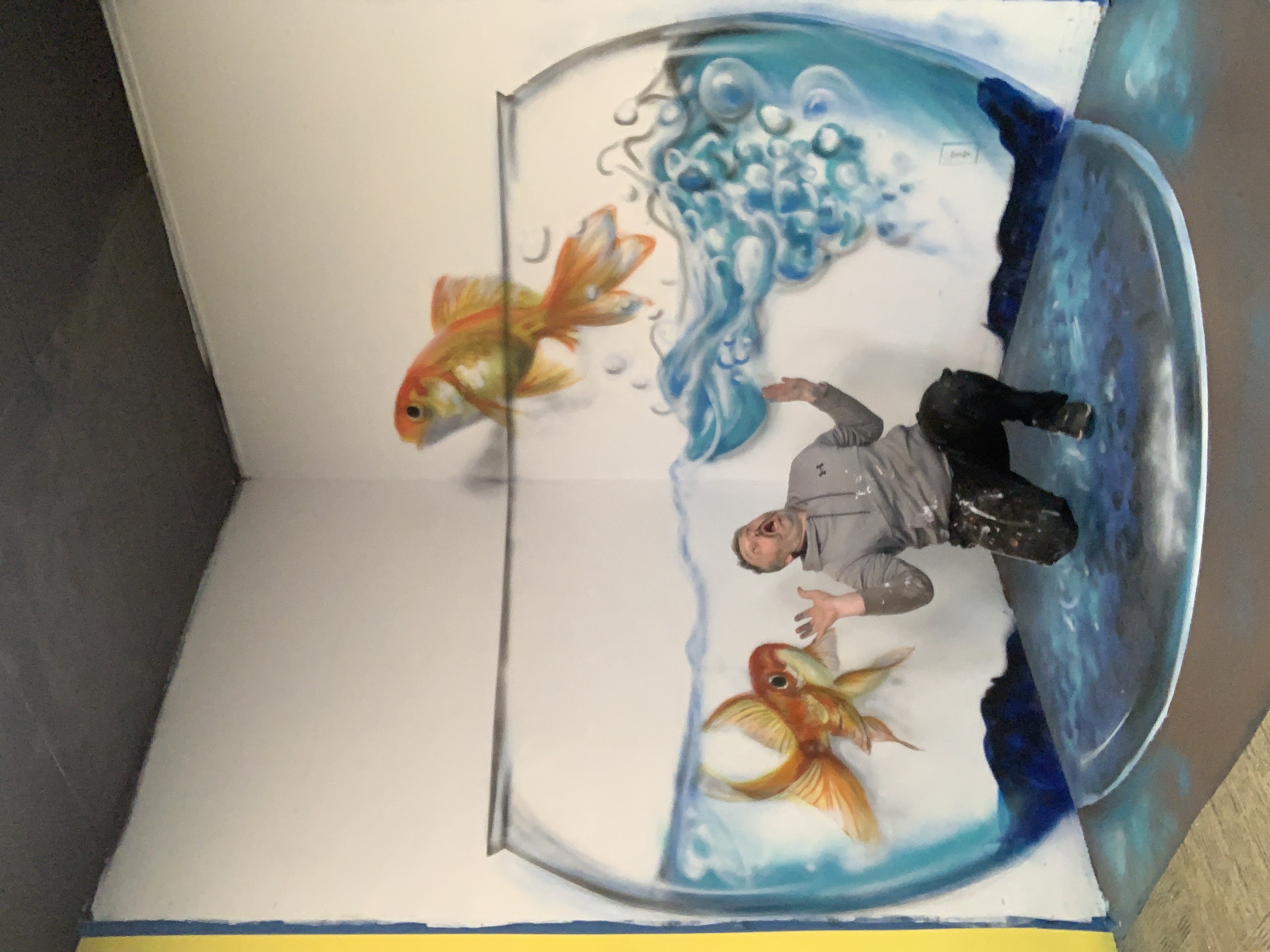 Mind-bending 3D illusion of giant goldfish bowl with realistic swimming fish, water and bubbles mural