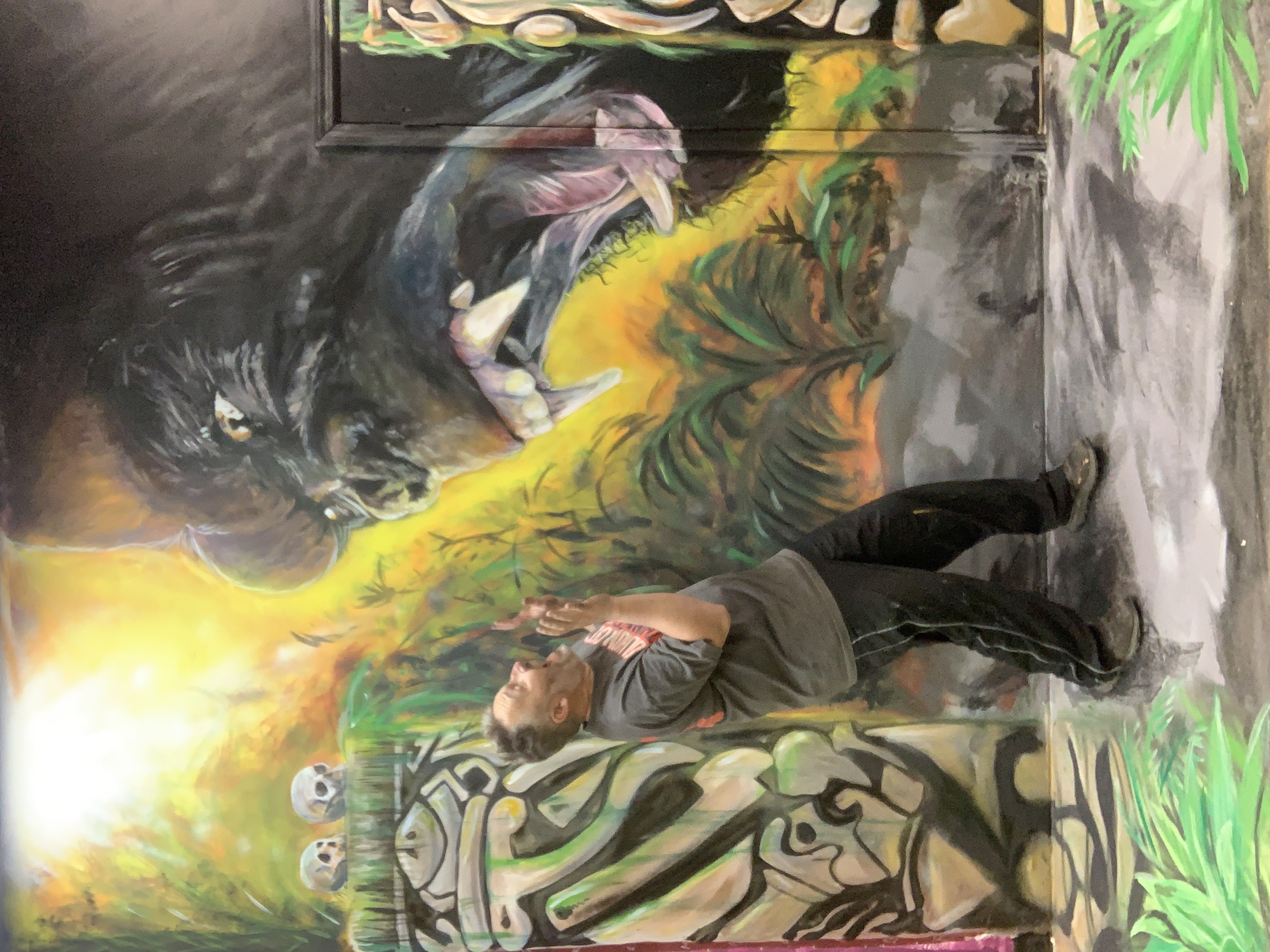 Dramatic large tropical jungle mural with roaring gorilla, skulls and lush foliage in adventure themed space