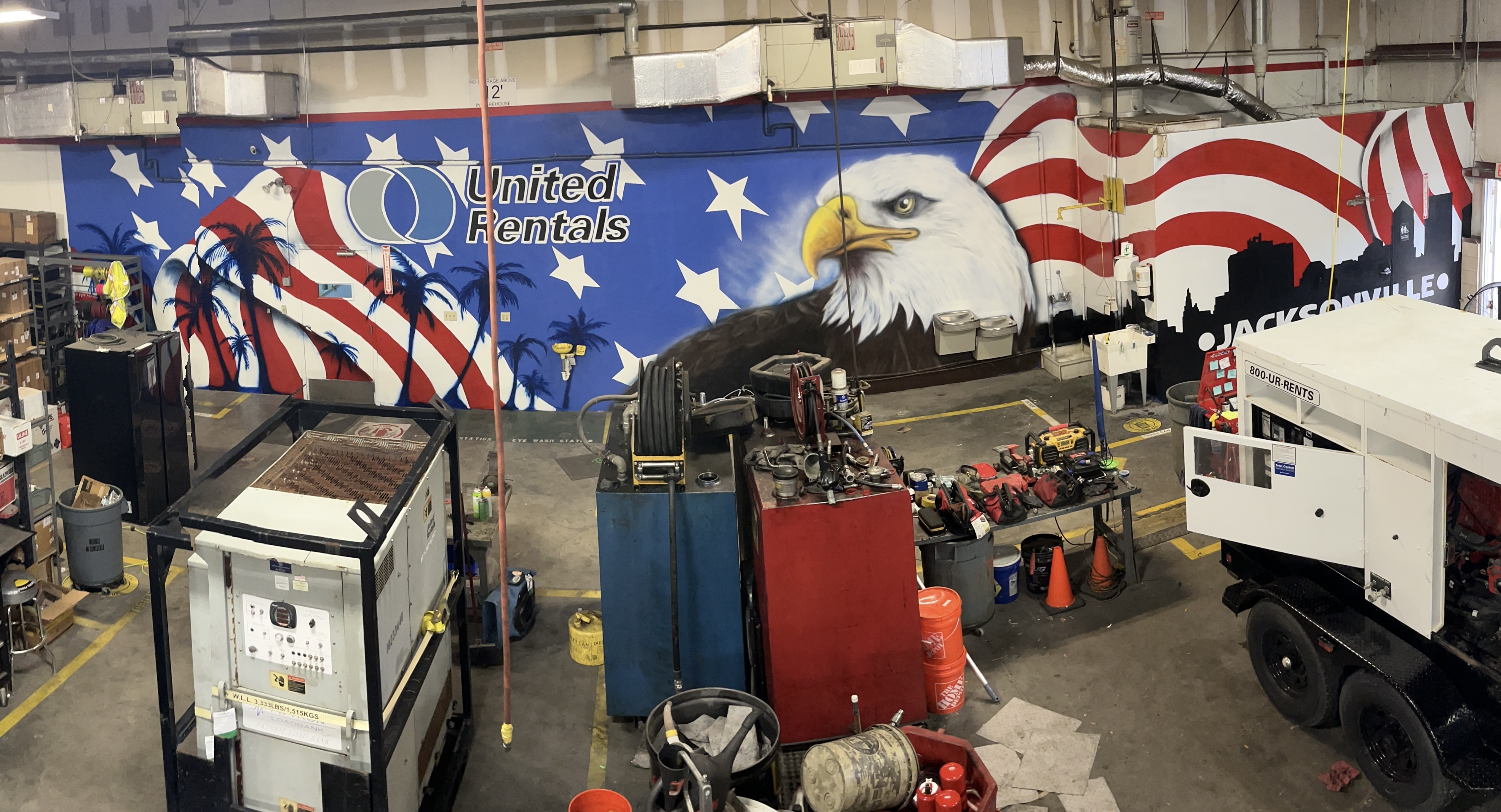 Large scale commercial mural with American flag, bald eagle, palm trees and Jacksonville skyline for United Rentals